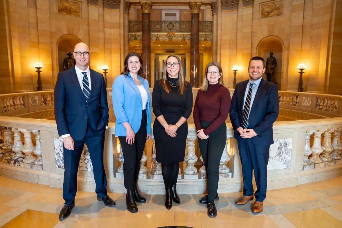 A group of Goff Public lobbyists in business attire at the Minnesota Capitol building
