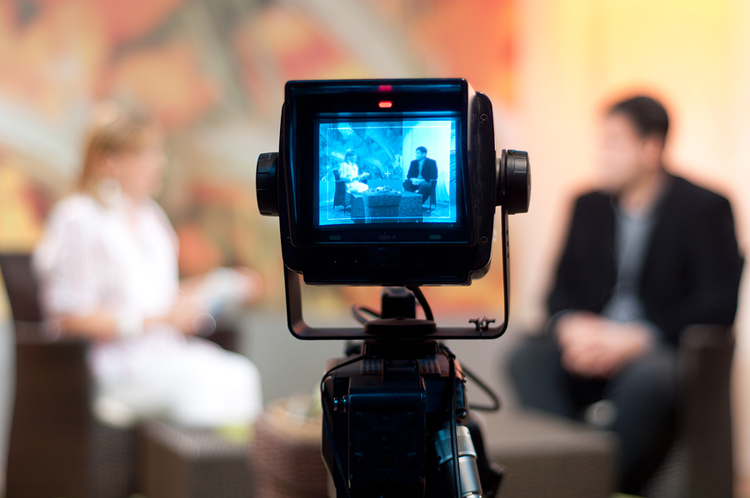 Video camera viewfinder recording a show in TV studio with the focus on the camera