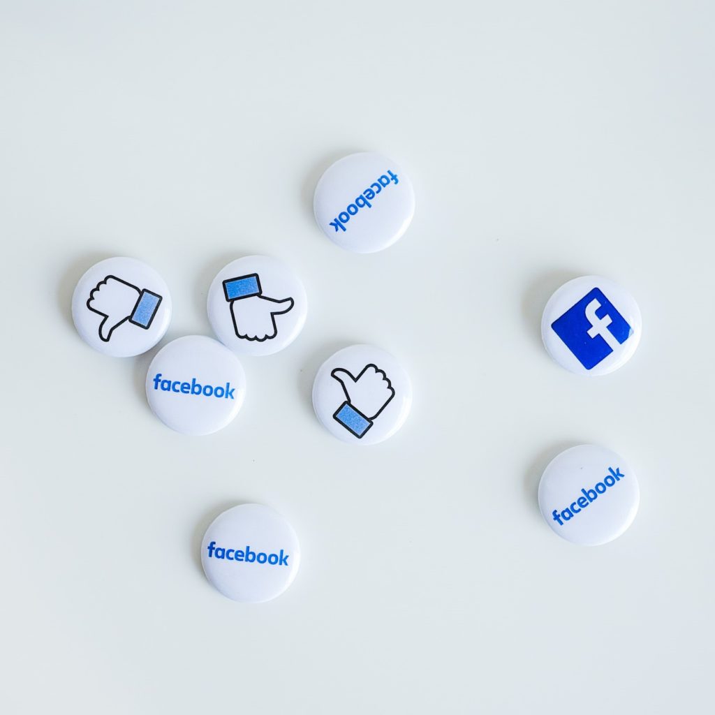 Various circles containing a thumbs up, thumbs down, and Facebook icon