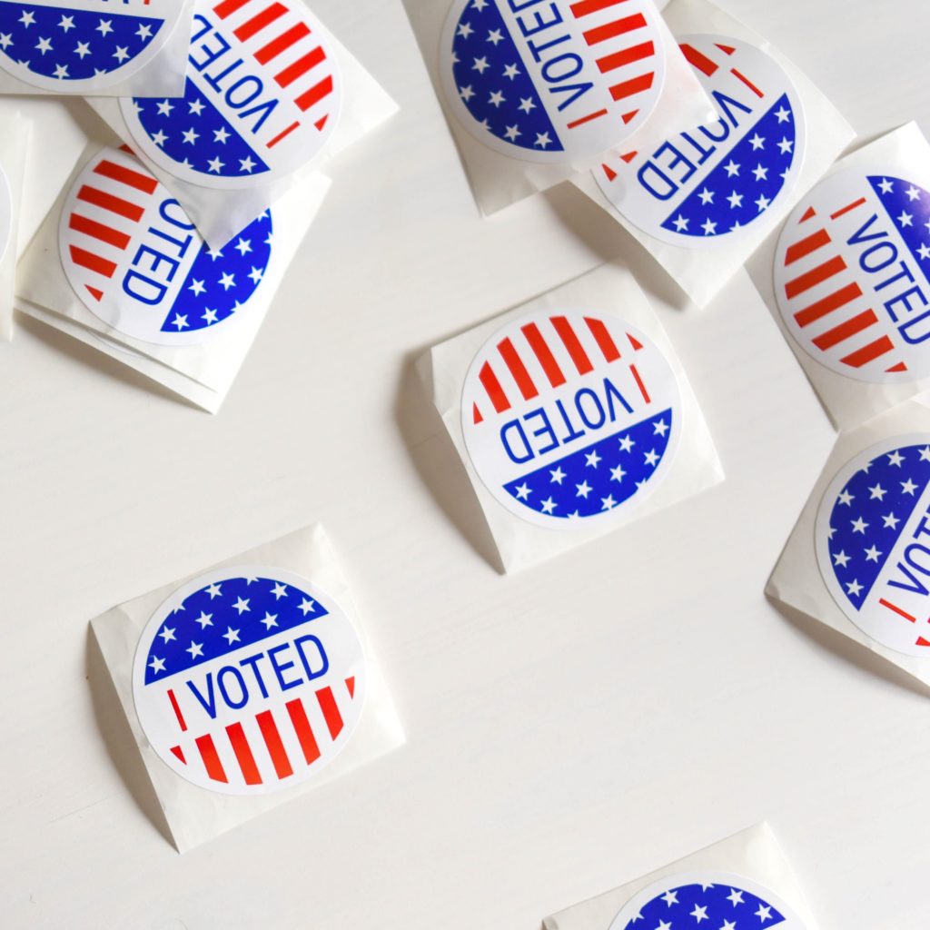 Numerous "I Voted" stickers scattered on a table