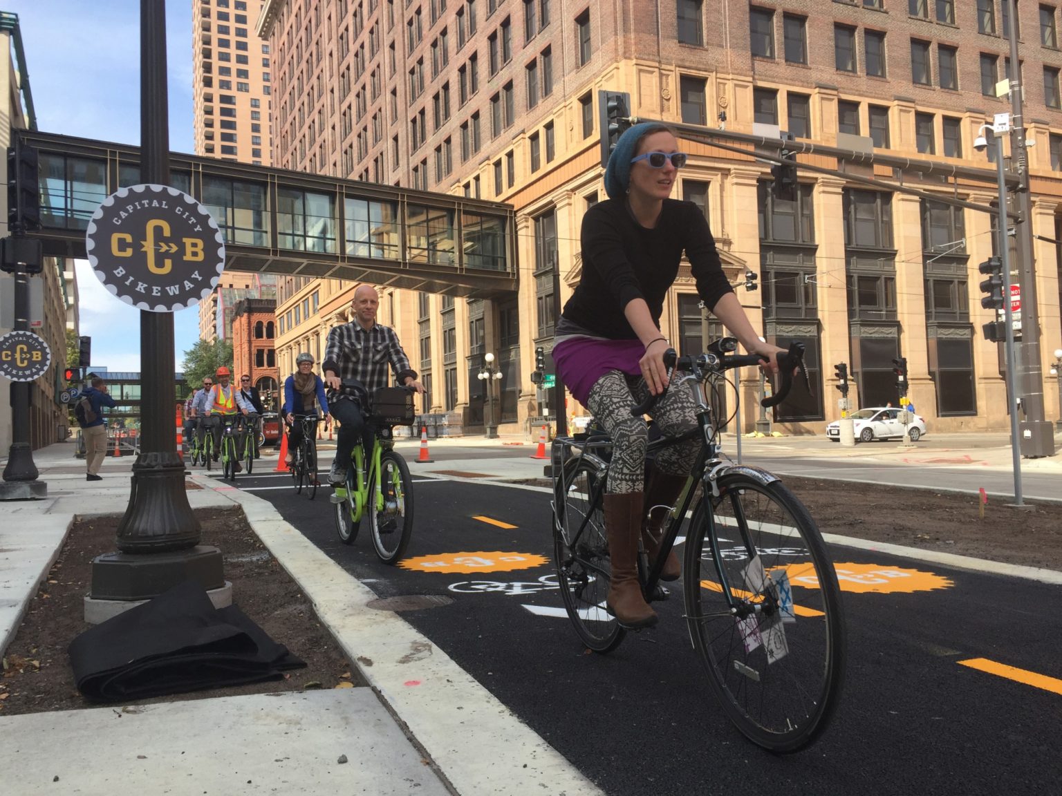 A group of bikers biking in a line fashion in Downtown, Saint Paul