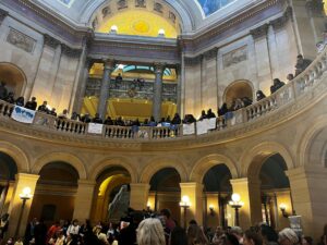 Large group of protestors on the first and second floor of the rotunda at the State Capitol