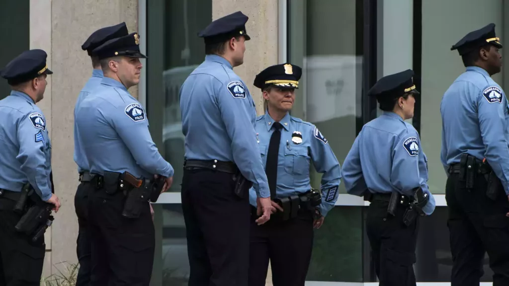 Photo of six uniformed police officers in a line