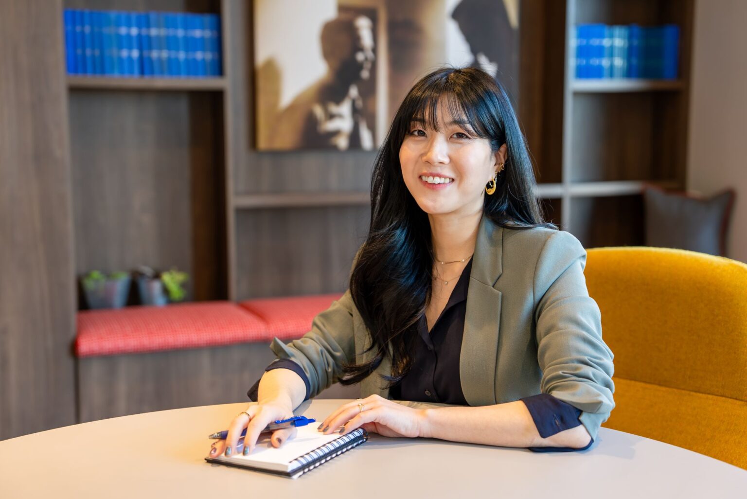 Jenny Alvermann sitting at a table with a notepad and pen