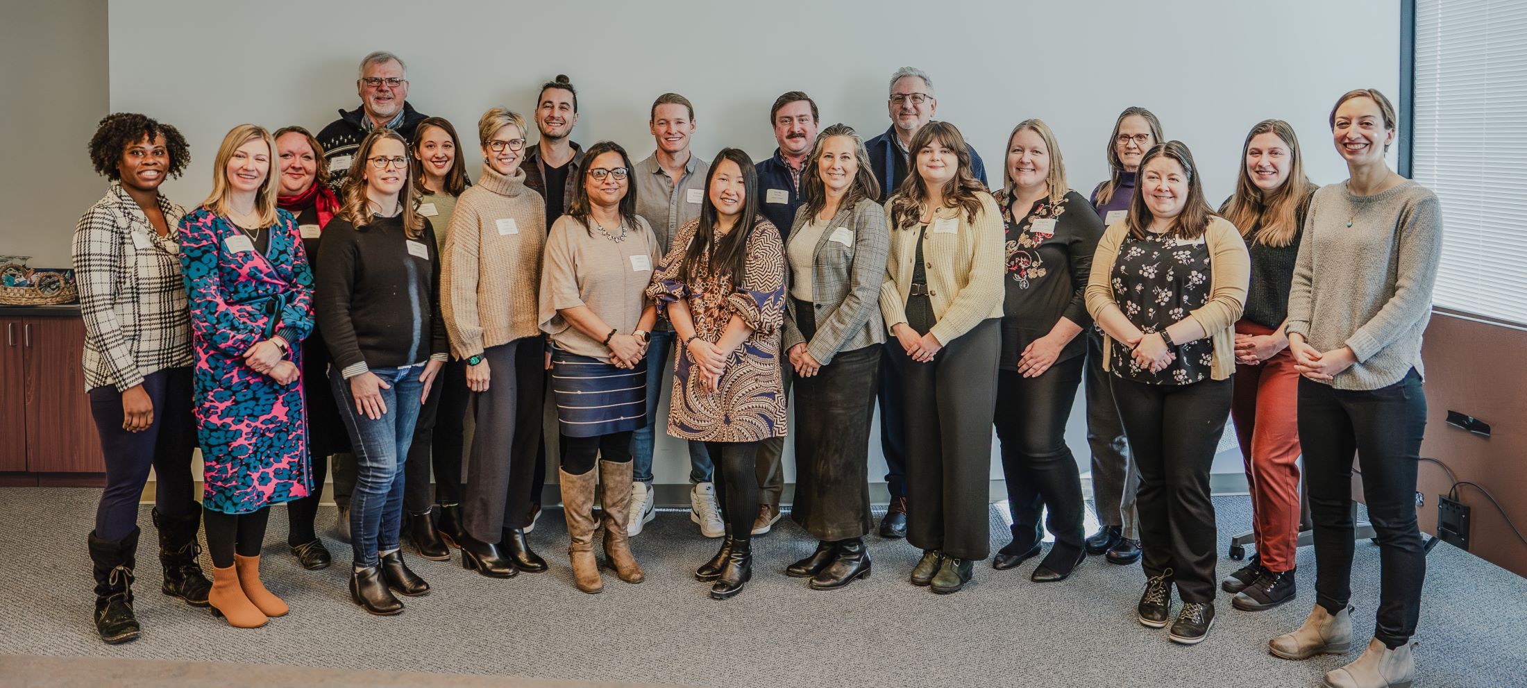 Twenty members of the Goff Comms Cohort pose for a photo.