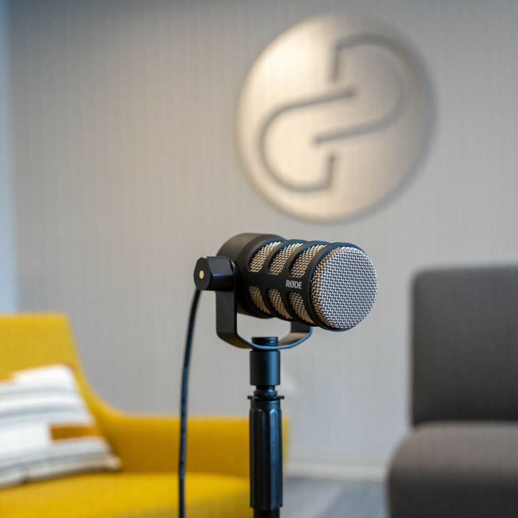 A podcast microphone with the Goff Public logo in the background