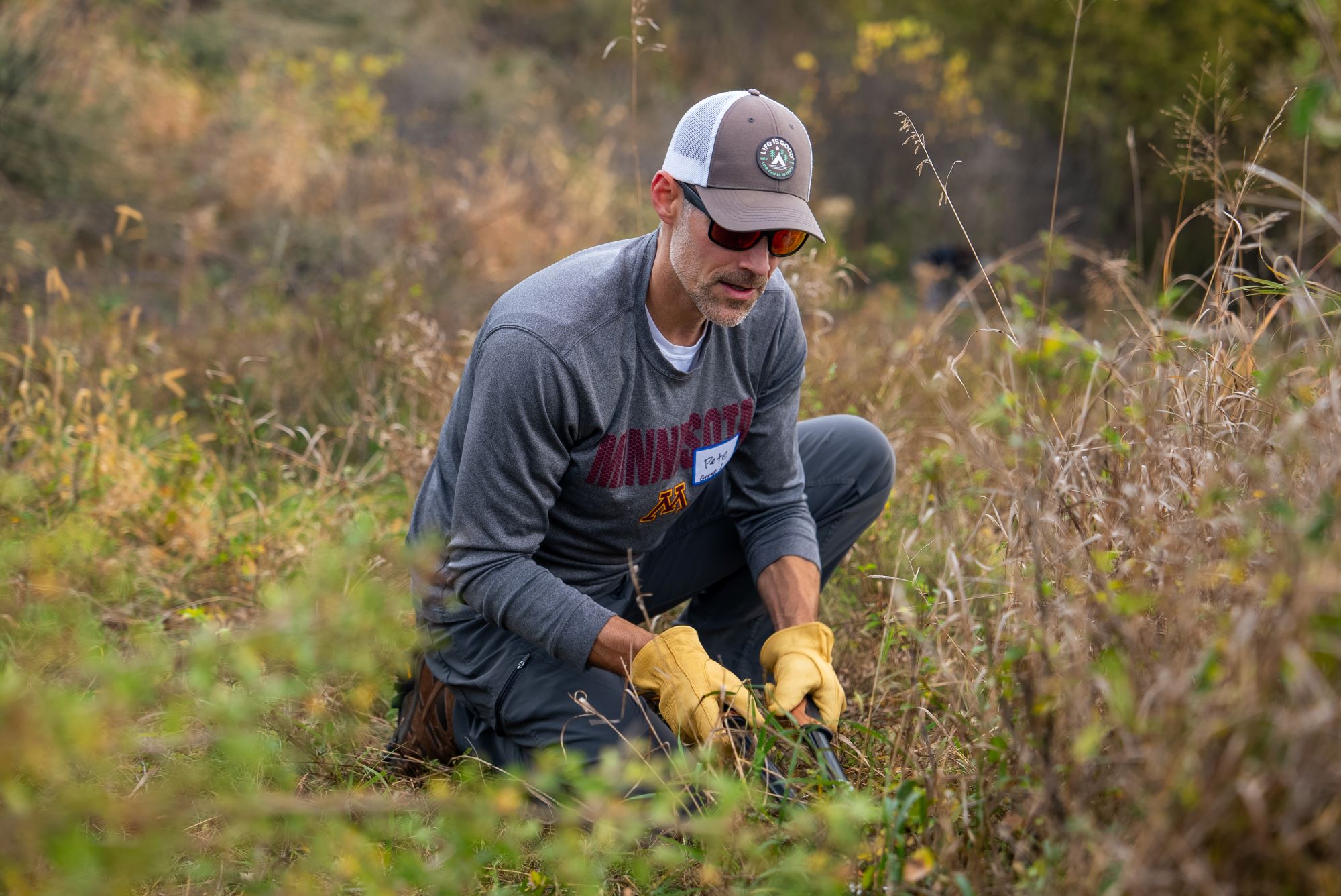 A Flint Hills employee plucks weeds at Pine Bend Bluffs