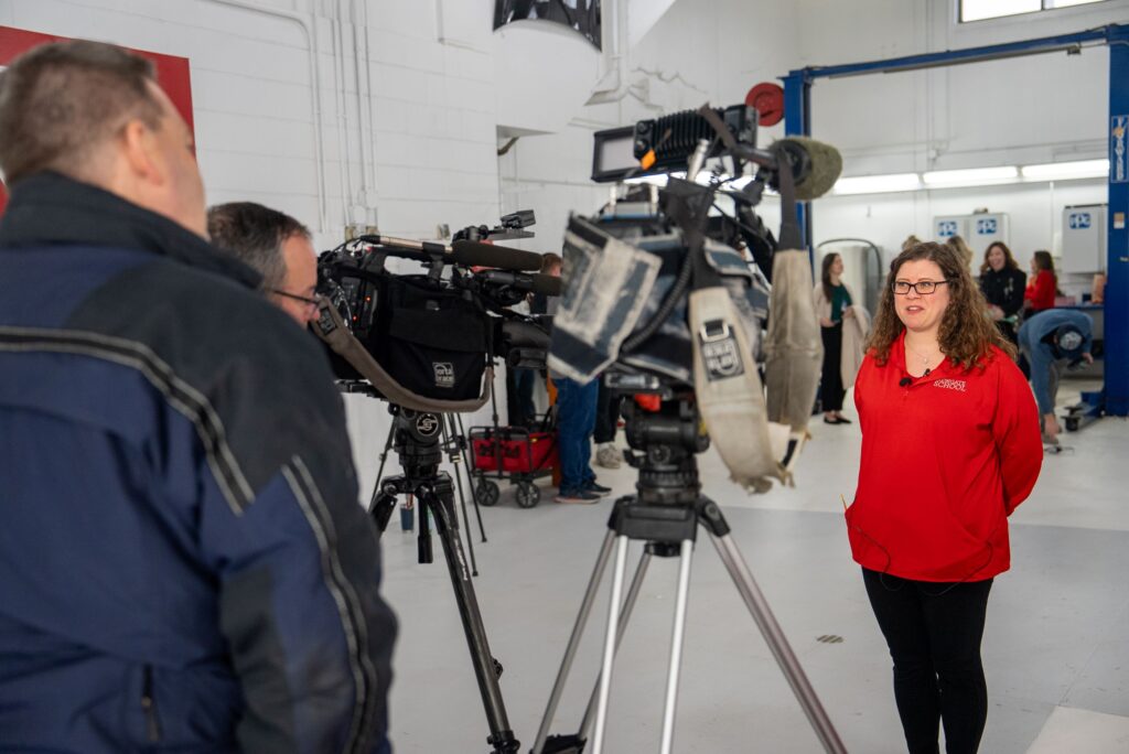 A woman is interviewed in front of a video camera