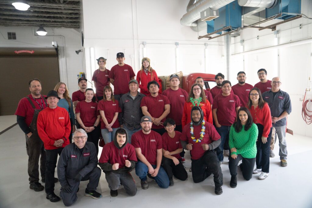 A group of Newgate School employees and students pose for a photo