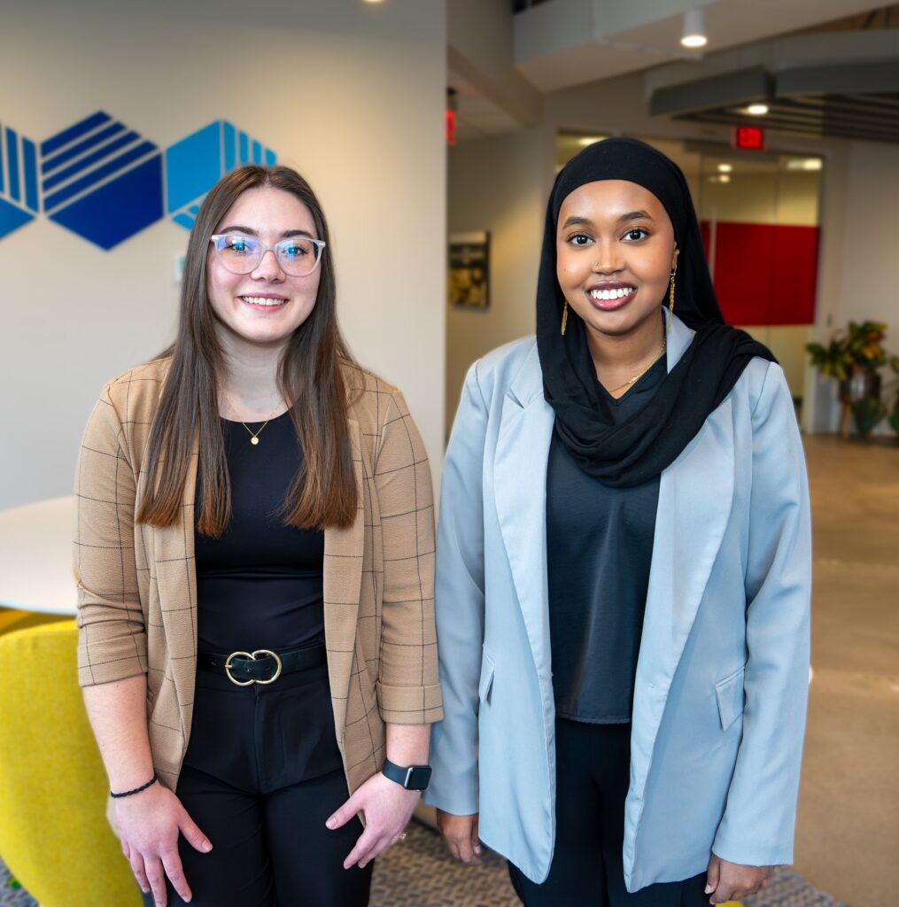 Two young women pose for a photo in the Goff Public office